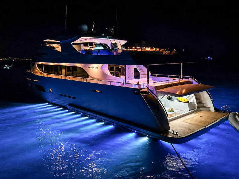 MY Panfeliss luxury charter yacht exterior at night with underwater lights on