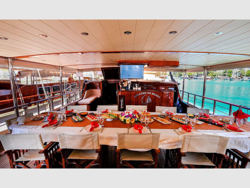 Ada Deniz gulet yacht outdoor aft deck dining table welcome setting