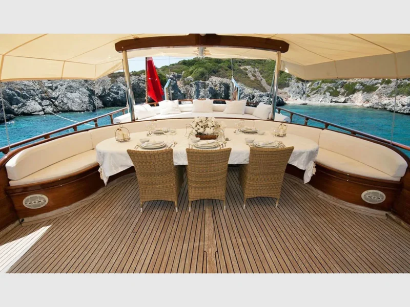 Arif Kaptan A gulet outdoor aft deck with dining table and sunbeds