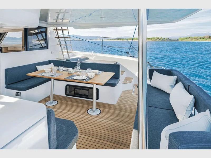 Aventura 37 catamaran outdoor aft deck lounge area and dining table