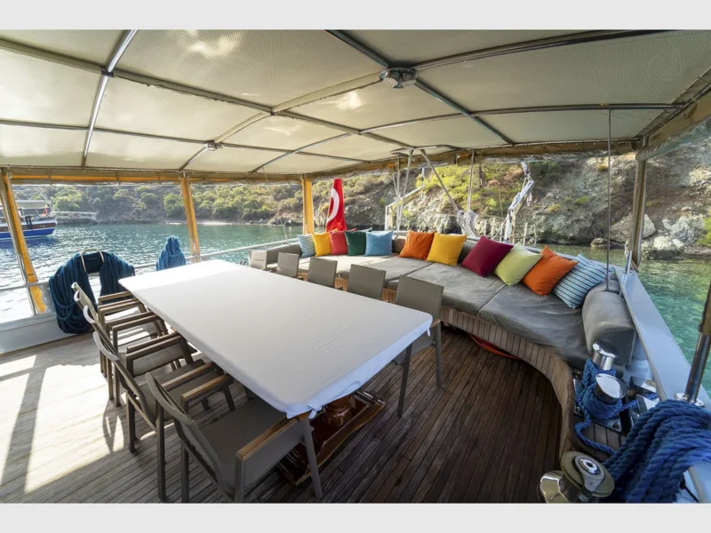 Prenses Lila gulet charter yacht outdoor aft deck dining table and lounge area wide angle