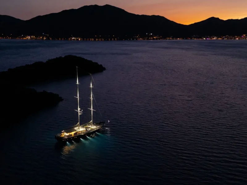 Ubi Bene gulet charter yacht exterior drone shot from distance in the evening