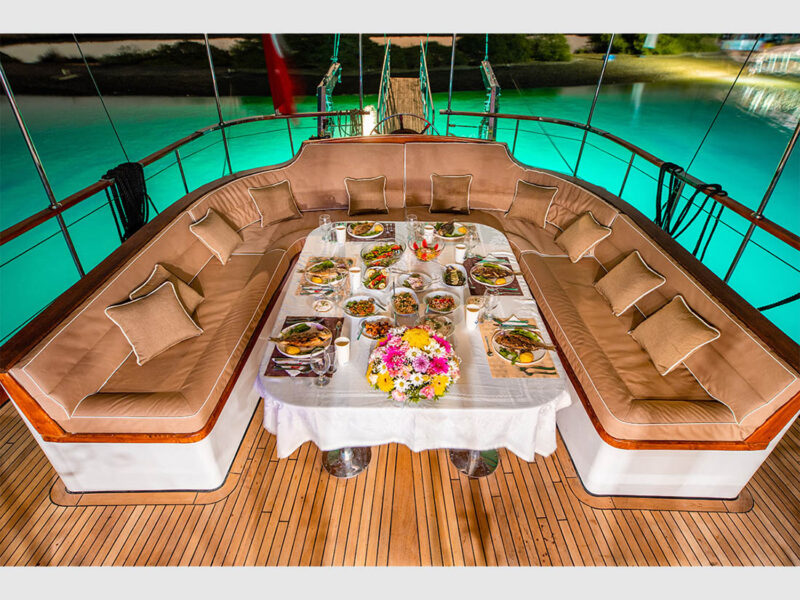 Afilli Gulet outdoor aft deck dining table at night