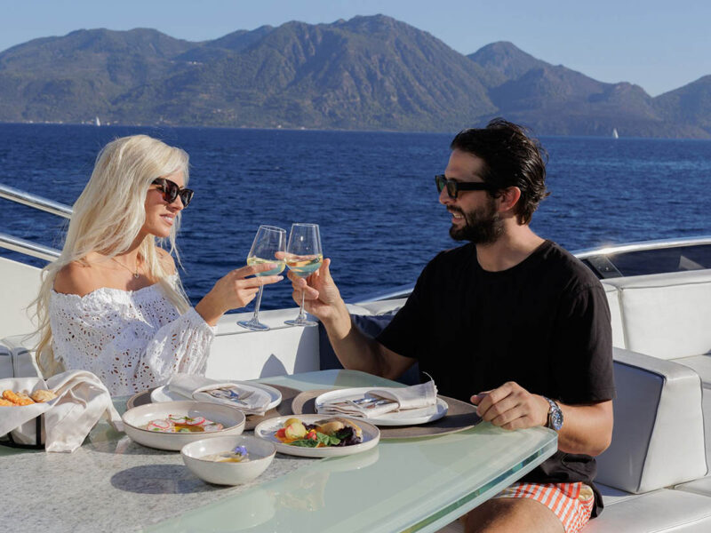 MY Why Not Dominator 780S charter yacht outdoor upper deck flybridge couple enjoying drinks
