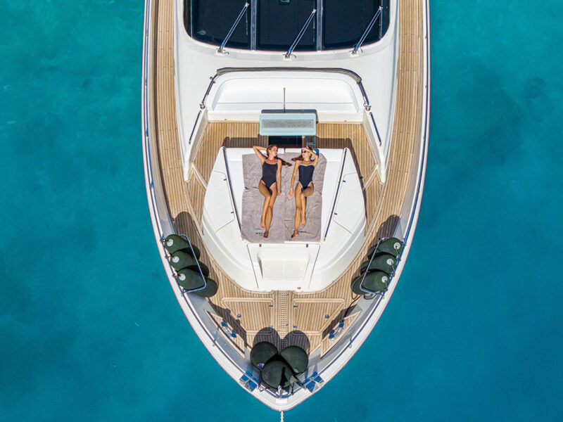 MY Why Not Dominator 780S charter yacht outdoor drone shot of fore deck lounge and sunbathing area from top