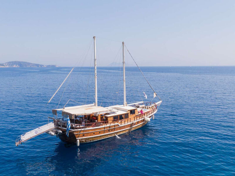 Rhodes blue cruise gulet exterior drone shot starboard aft quarter
