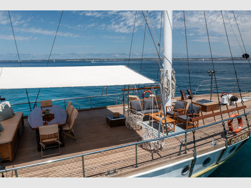 Gideon gulet Croatia charter yacht outdoor foredeck dining table and lounge area