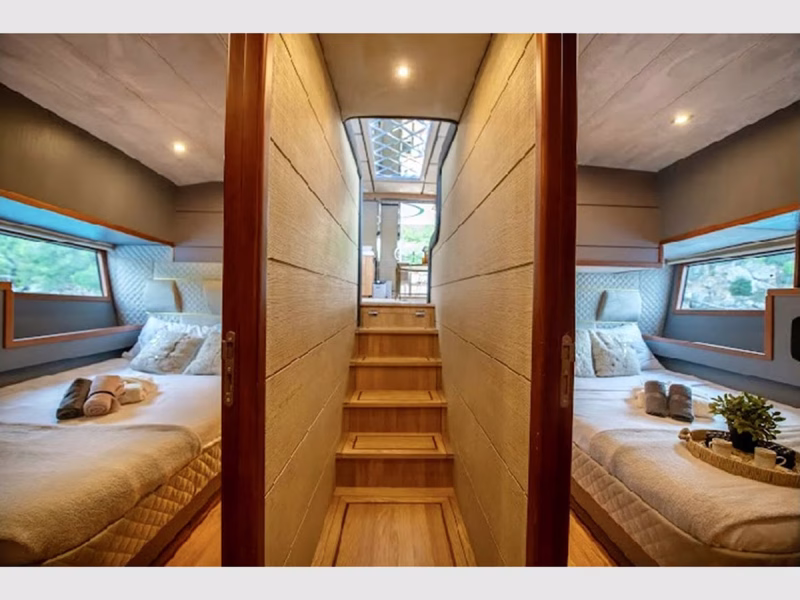 Golden Blue motor yacht interior lower deck hallway stairs to saloon