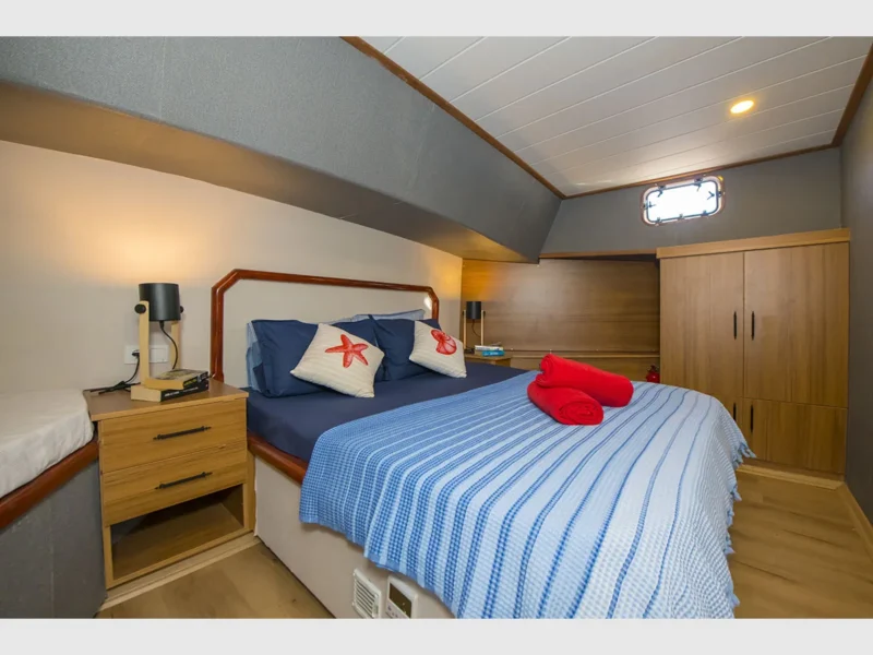Flores gulet charter yacht interior fore VIP cabin wide angle