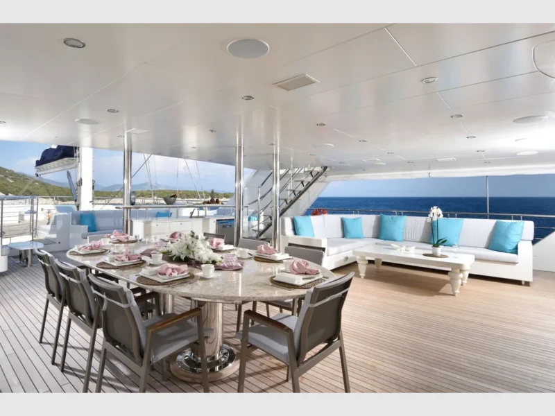 Meira motorsailer charter yacht outdoor main deck dining table and lounge area