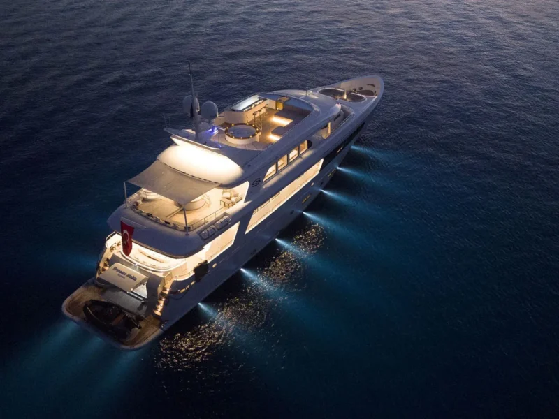 Princess Melda motor yacht charter, exterior drone shot from starboard aft quarter at night